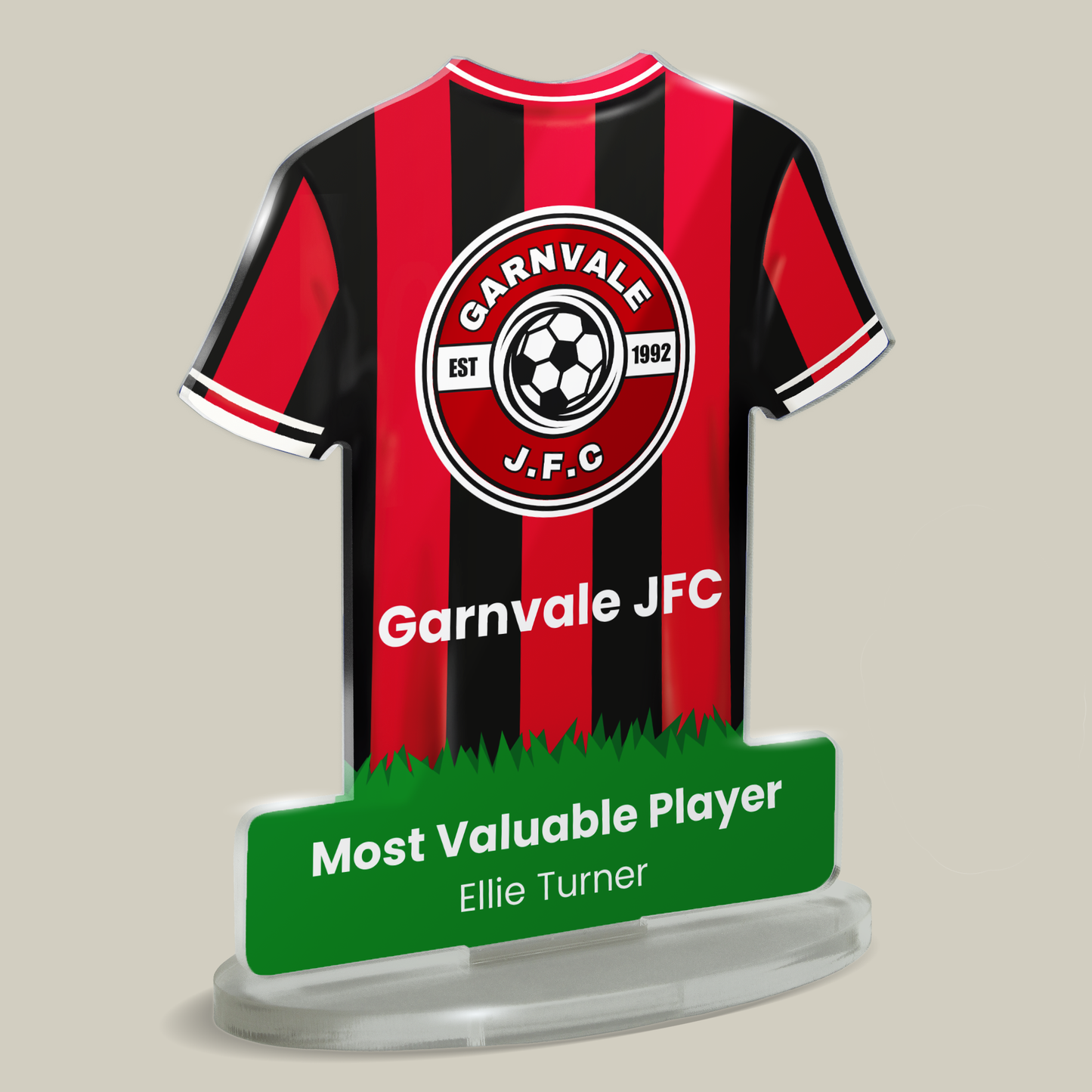 Acrylic t-shirt plaque showing red and black stiped sports shirt with 'Garnvale J.F.C.' branding and 'Most Valuable Player' text below. Plaque shown on beige background.