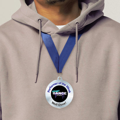 Acrylic personalised medal with blue ribbon showing silver design with 'Street Dance Studio image' and 'Performer of the Week', 'Well done!' wording. Medal worn around neck.
